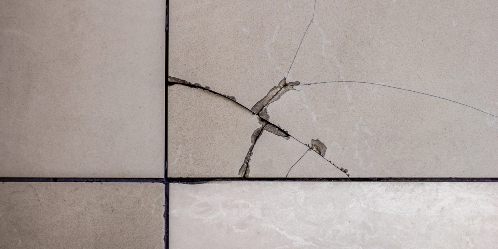 tile flooring with cracks in it.